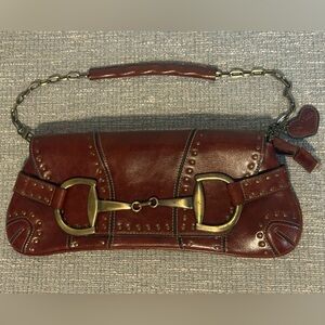 Rina Rich Burgundy Leather with Brass bit hardware. Beautiful Vintage piece.